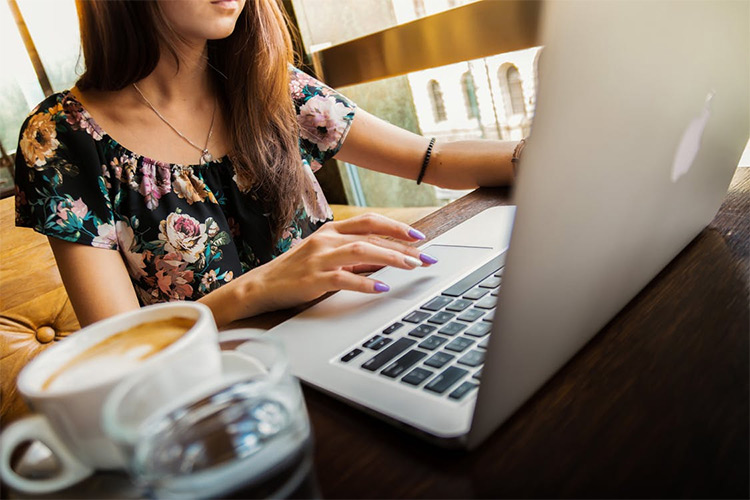 Girl blogging on laptop