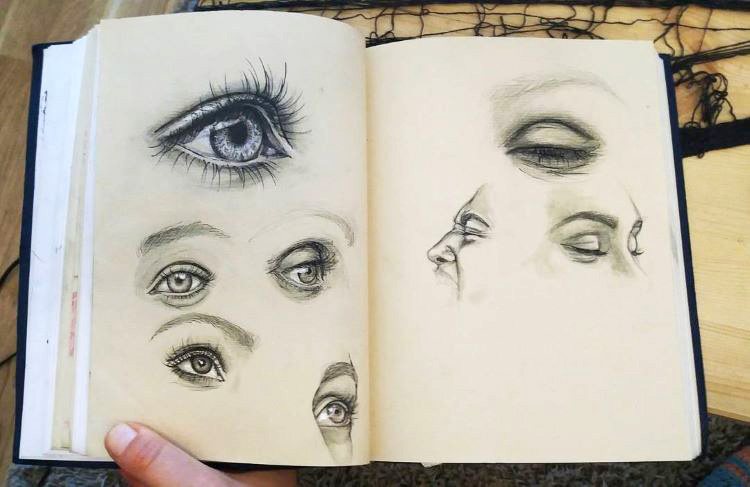 Holding sketchbook with eyes inside