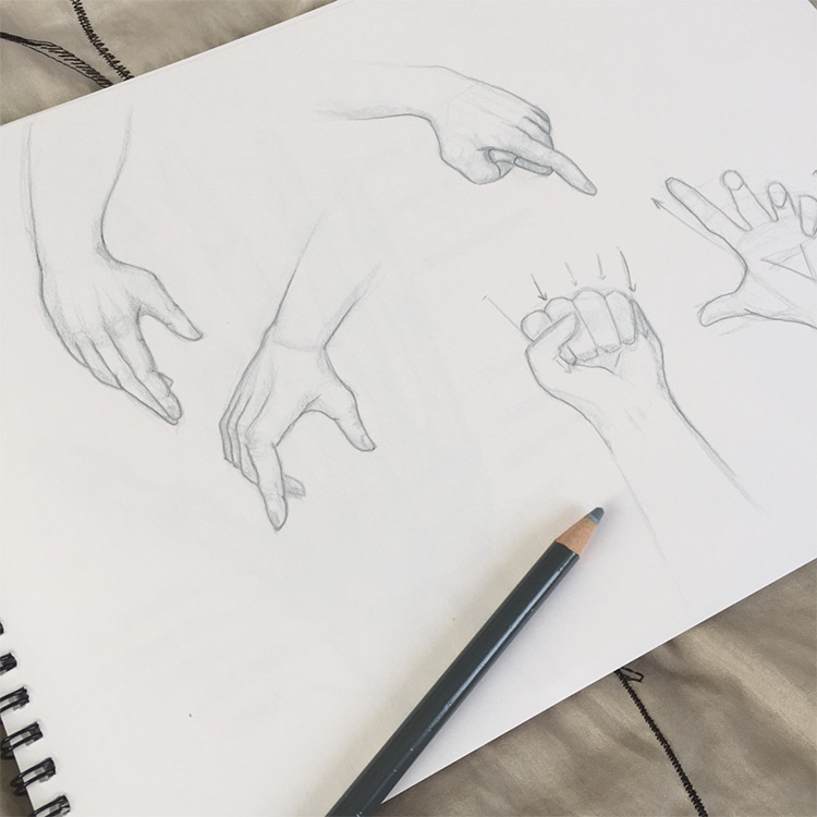Clean drawings of hands in sketchbook