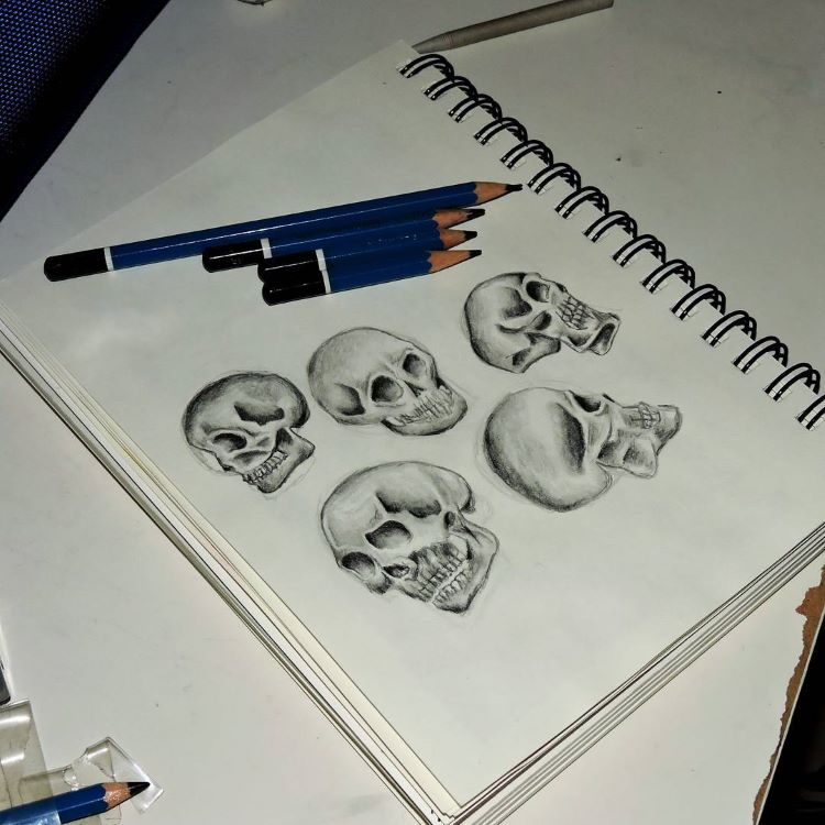 Rough skull sketches in notebook